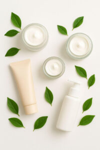 Flat lay of non-comedogenic moisturizers with fresh leaves on a bright background.