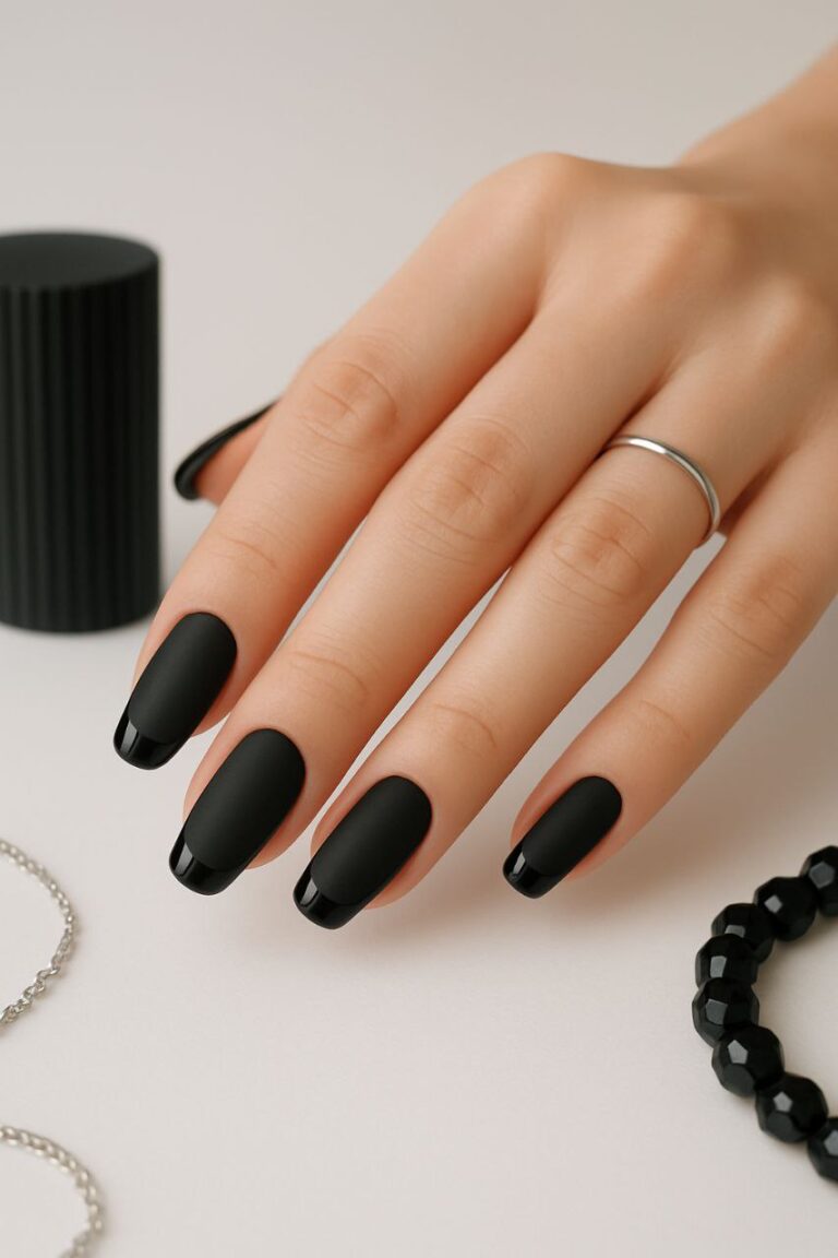 “Close-up of matte black nails with glossy French tips, modern nail art style”